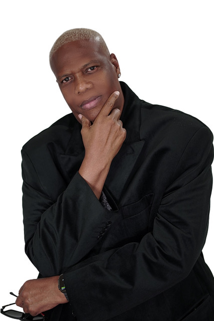 The Mad Stuntman in a black suit, studio portrait